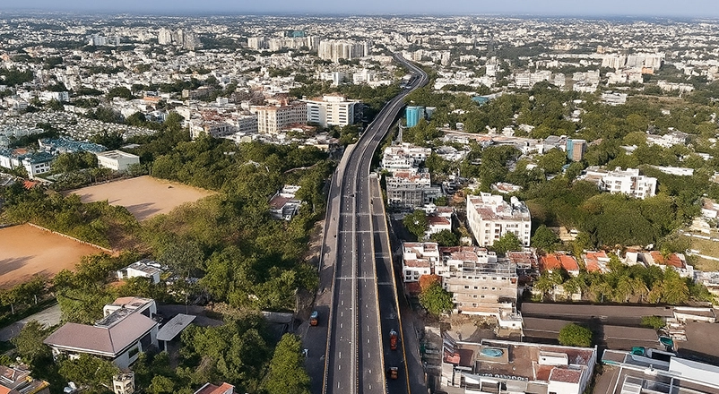 The benefits of buying plots or land near major flyovers in Coimbatore and its growth in property values.
